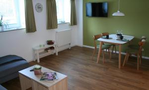 a living room with a table and a dining room at Lahn Hotel in Biedenkopf