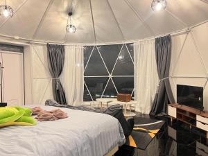 a bedroom with a bed in a tent at Green bus view inside hills khaokho in Khao Kho