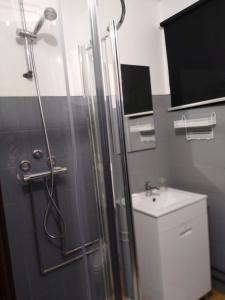 a bathroom with a shower and a sink at Moradia Lili in Ronqueira