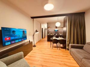 a living room with a large flat screen tv at House 74 in Verona