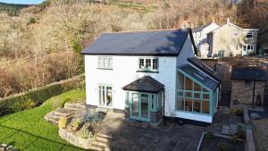 an aerial view of a white house with a black roof at Peaceful Haven: Nature, Luxury, Wellbeing & Cuisine in Risca +23 photos