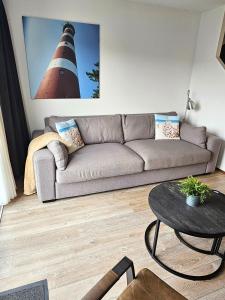 ein Wohnzimmer mit einem Sofa und einem Leuchtturm in der Unterkunft Borndiep Amelander Kaap 34 in Hollum