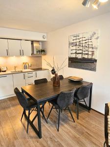 a kitchen with a dining room table and chairs at Borndiep Amelander Kaap 34 in Hollum