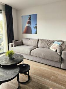 a living room with a couch and a table at Borndiep Amelander Kaap 34 in Hollum +14 photos