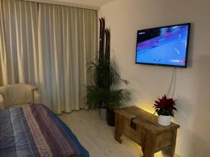 a bedroom with a flat screen tv on the wall at Disentiserhof in Disentis
