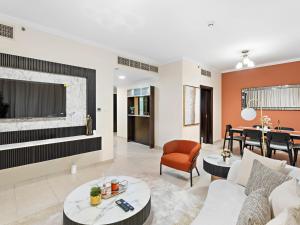 a living room with a couch and a table at Charming & Vibrant 1Bedroom In Marina Quay in Dubai