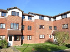 a large brick building with a yard in front of it at Apartment in Epsom With Free Parking in Epsom