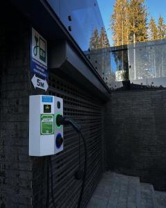a gas pump on the side of a building at Twins Hotel & Spa in Bukovel