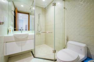 a bathroom with a shower and a toilet and a sink at Raddison Luxury Apart - Vinhome Central Park, Landmark 81 Area and Great Park in Ho Chi Minh City