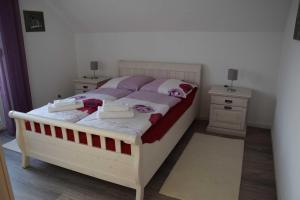 a bedroom with a white bed with two night stands at Ferienwohnung-Herbolzheim in Herbolzheim