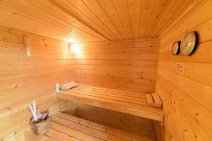 a wooden sauna with a clock on the wall at Ferienwohnung-Herbolzheim in Herbolzheim