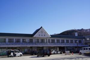 a large building with a clock on top of it at The Hakuba Station Room in Hakuba