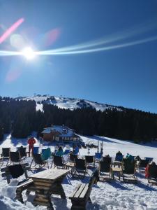 a group of chairs sitting in the snow at President Kop Apartman 106 in Kopaonik