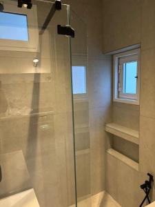 a shower with a glass door in a bathroom at Casa di Leonardo Elegant & Comfort in Bari