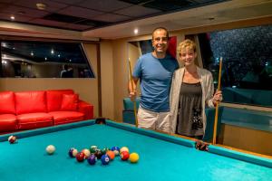 a man and a woman standing next to a pool table at M/S Nephtis Nile Cruise in Luxor