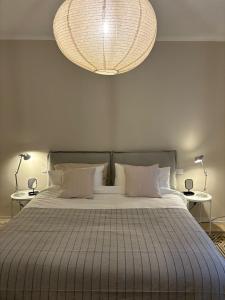 a bedroom with a large bed with a large chandelier at Casa di Leonardo Elegant & Comfort in Bari