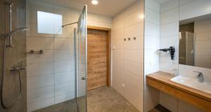 a bathroom with a shower and a sink at Penker Wirt Zimmer BANK in Penk +7 photos