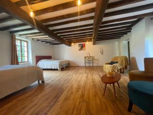 Loubens的住宿－Domaine La Tour，客房设有两张床、一张沙发和一张桌子。