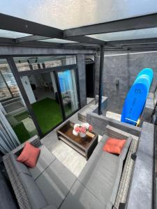 an overhead view of a living room with a blue surfboard at Secret Surf House. Casa de playa. in Playa del Hombre +5 photos