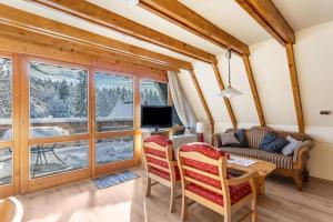 a living room with a table and chairs and a television at Ferienhaus Moritz in Siegsdorf