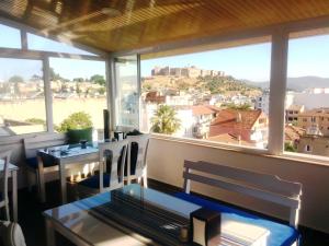a room with large windows and a view of a city at Urkmez Hotel in Selçuk