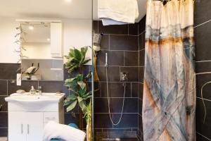 a bathroom with a shower curtain and a sink at Wildwest Lounge in Eppingen +18 photos