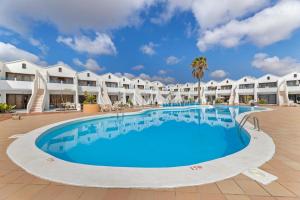 a large swimming pool in front of a resort at Home2Book Sunny Apt Pool & Beach, Costa Teguise in Costa Teguise