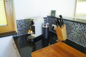 a kitchen counter with a coffee maker on a wall at Das Ferienhaus in Achenkirch in Achenkirch