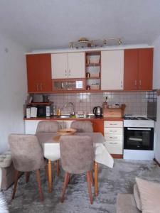 a kitchen with a table and chairs in a room at Apartman Royal Vlašić in Vlasic