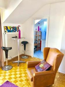 - un salon avec un canapé et deux tabourets de bar dans l'établissement Ganze Wohnung mit Balkon,schöne Aussicht,Küche,Bad,Wifi, à Bâle
