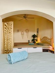 a bedroom with a bed with a blue towel on it at Villa with sea view and luxury heated pool in San Miguel de Abona