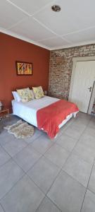 a bedroom with a bed and a brick wall at Twin peaks in Underberg