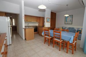 a kitchen and dining room with a table and chairs at Rocha Praia Mar Beach Front Line Bay in Portimão