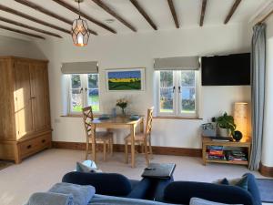 a living room with a table and chairs at The Dale at Greystones - Luxurious annexe with stunning view in Buckden