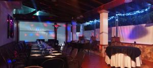 a dining room with tables and chairs and lights at Hotel Marinella in Pizzo