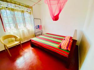 a small room with a bed and a window at Hamba Hostel for Safari in Hambantota