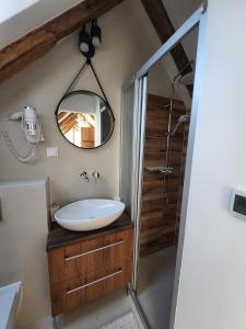 a bathroom with a sink and a mirror at Apartmán v Podkroví in Kremnica