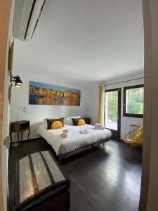 a bedroom with a large bed in a room at Villavos- La Vassal in Cassis