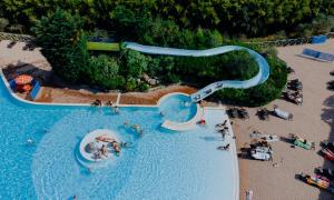 an aerial view of a water park with people on a beach at Estivo Premium Deluxe mobile homes on Camping Del Sole Village in Iseo