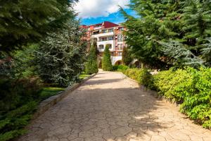 a cobblestone path in front of a building at Menada Apartments in Marina Cape in Aheloy