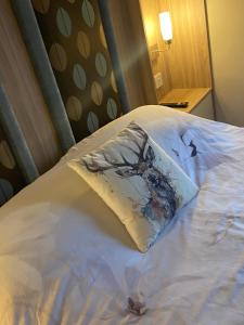 a pillow sitting on top of a bed at Otters Rural Retreat - Private Hot-Tub & Free Golf for guests included in Swarland