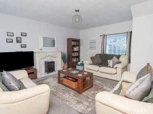 a living room with two couches and a fireplace at The Old Smithy in Morpeth