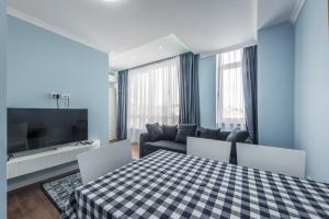 a living room with a table and a couch at Sky Apartments in Durrës