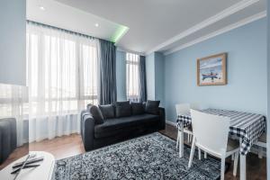 a living room with a couch and a table at Sky Apartments in Durrës