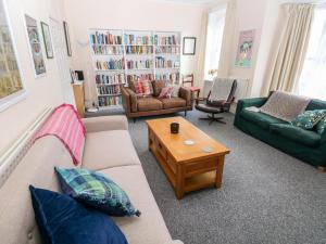 a living room with two couches and a coffee table at The Bookshelf in Oystermouth