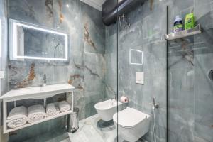 a bathroom with a shower and a sink and a toilet at Sky Apartments in Durrës +89 photos