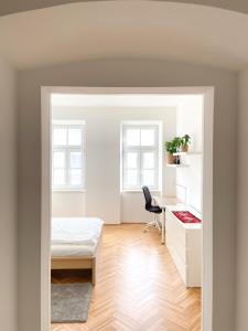 - une chambre avec un bureau, un lit et une chaise dans l'établissement Central Vienna Luxury Stay w/ parkview, near metro, à Vienne