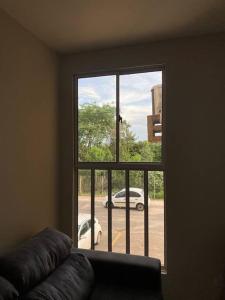 a window with a view of a car parked outside at Apartamento em Várzea Grande MT in Várzea Grande