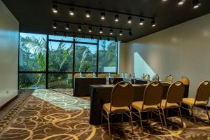 a conference room with a long table with chairs and a large window at Sheraton Tucumán Hotel in San Miguel de Tucumán