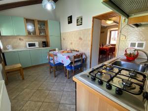 a kitchen with a stove and a table in it at Marlene in Cannobio